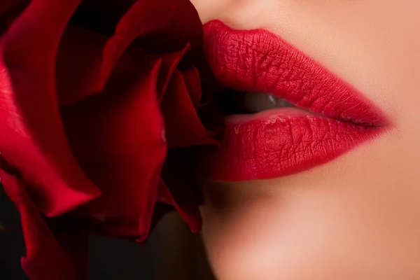 Close up of red glossy female lips. Beautiful woman lips with rose. — 图库照片