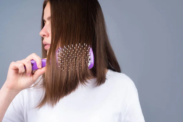 stock image Close up portrait of happy beautiful girl with shiny hair with comb.