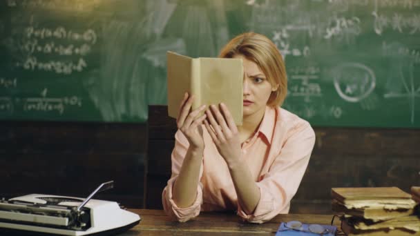 Young attractive female student holding book. — Stock Video