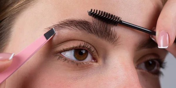 Woman on the brow beauty procedures. Care for brows, eyebrows lamination. Macro close up of brows. — Stock Photo, Image