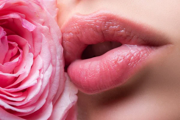 Natural lips. Lips with lipstick closeup. Beautiful woman mouth with rose. — Stockfoto