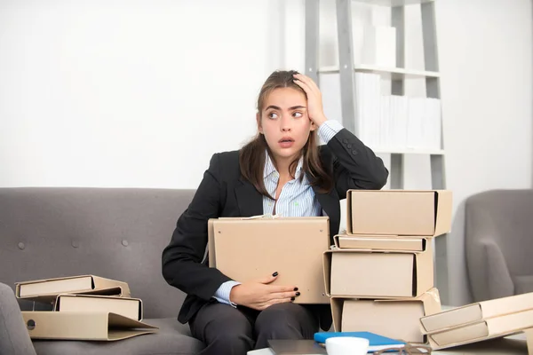 Busy business woman with many folders of documents, secretary girl working alone late in office. Angry sad secretary, upset accountant employee. — Stockfoto