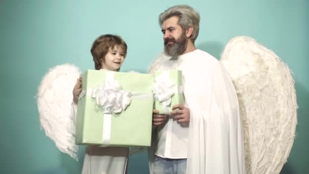 Valentin father and son with present gift. Family men with feathers wings of Cupid Valentines Day. Parenting, parent with child boy, childhood. — 图库视频影像