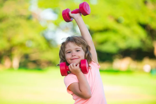 Fitness dumbbells kid exercise workout outdoor. Boy sporty child with dumbbells. Healthy activities kids lifestyle. — Foto Stock