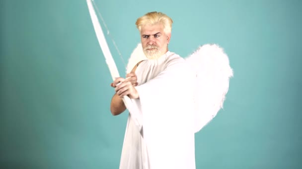 Valentin with bow arrow ready to shoot. Funny bearded man with feathers wings of Cupid Valentines Day. — Stockvideo
