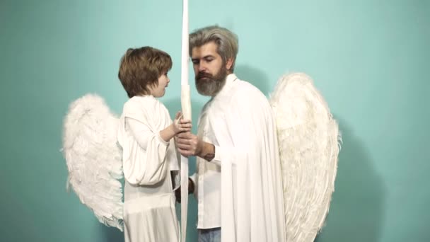 Valentines Day concept. Angels father and son cupid aiming with bow and arrow. — Stock Video