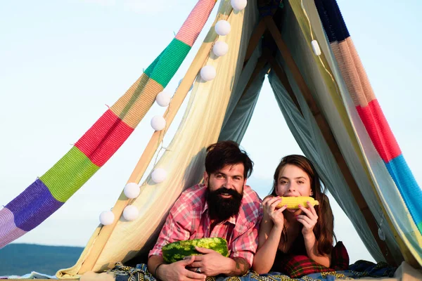 Hikers couple eat watermelon camping on nature in tent. Romantic lovers on vacation camping. Morning breakfast with lovers on nature. Organic food. — 图库照片