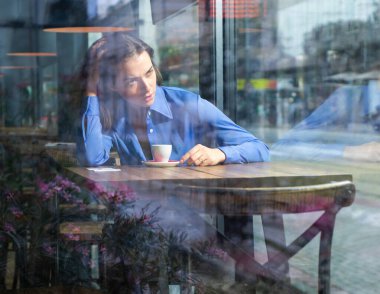 Düşünceli bir kavram. Pencere camından dışarı bakan bir kadın. Dışarıdaki zarif genç bayanın şehvetli portresi..
