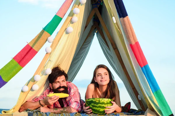Romantic couple eat watermelon in tent camping on nature background. Adventure for young friends on summer day. — 图库照片