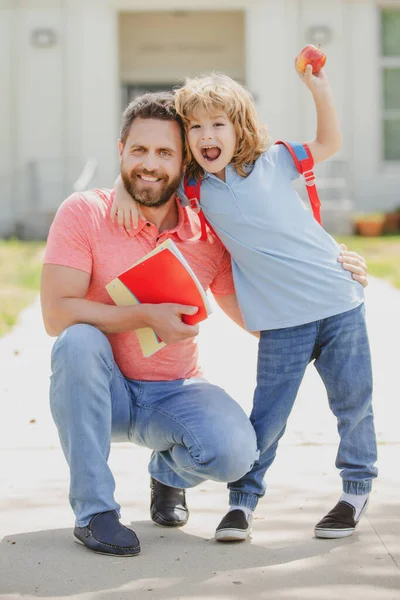 Happy father and son come back from school. School, kids education and outdoor concept. — Stock Photo, Image