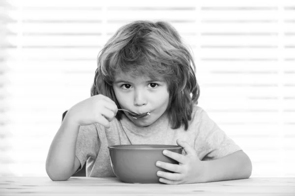 Caucasian toddler child boy eating healthy soup in the kitchen. — Stock Photo, Image