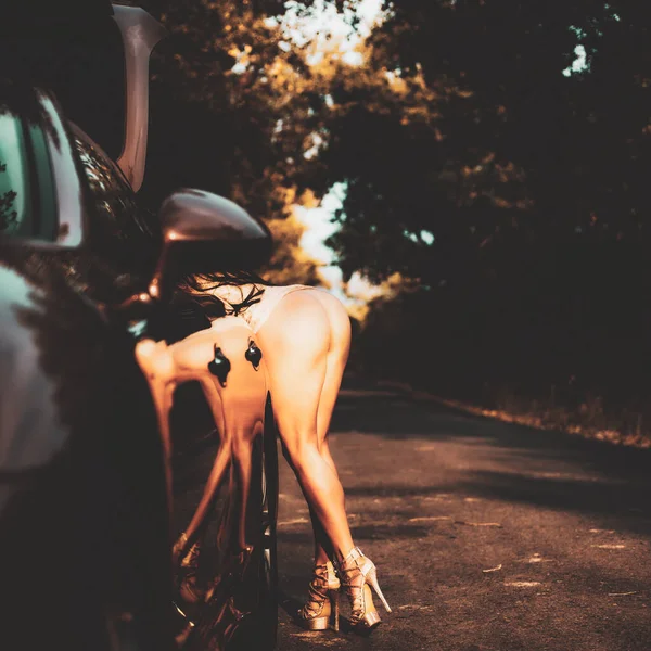 Sensual seductive young womans buttocks. Ideal womans butt, posing on car background. — Fotografia de Stock