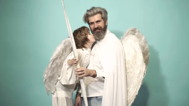 Funny cupid, father and son on valentine day with bow arrow shooting. Love family concept. Fun angels. Valentin man with angel wings. Valentines Day. — Stockvideo