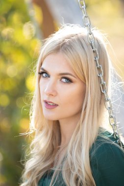 Genç ve şık bir kadının yüzünü kapatın. Güzel, düşünceli, açık hava portresi kızı. Genç sarışın kadın güneşli yaz gününde.