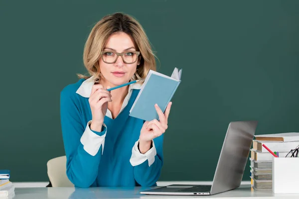 Portret van een vrouwelijke leraar, een zakenvrouw die les geeft aan scholieren op schoolbord. — Stockfoto