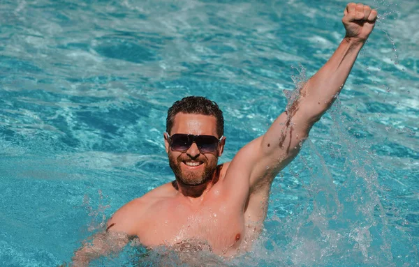 Summer man. Guy in swimming pool water. Pool spa resort. Summertime vacation. — Stock Photo, Image