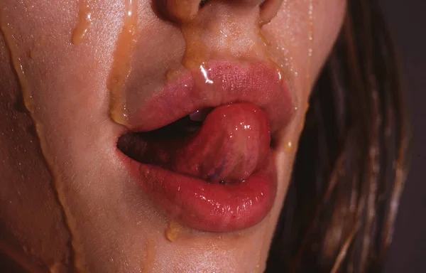 Mouth with honey close up. Honey dripping on sexy girl lips. Eating honey. — Stock Photo, Image