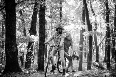 Aşık bir çift, Forest Park 'ta bisiklete biniyor. Bisikletle romantik bir randevu. Sakallı adam ve kadın sonbahar ormanında dinleniyor. Romantik bir çift randevuda. Tarih ve aşk. Ormanda sonbahar günü yürüyüşü
