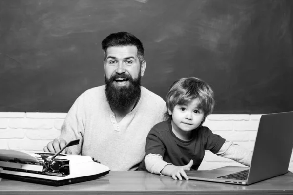 Teacher helping kids with their homework in classroom at school. Back to school. Parent Teacher. Man teaches child. First day in school. Young adult concept. Father and son. — Stock Photo, Image