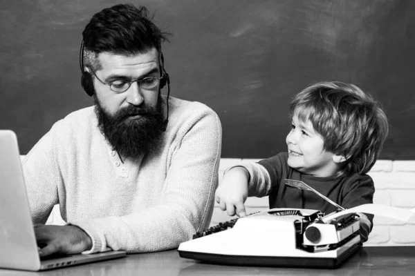 Back to school. Young boy doing his school homework with his father. Teacher helping kids with their homework in classroom at school. Preschool pupil — Stock Photo, Image