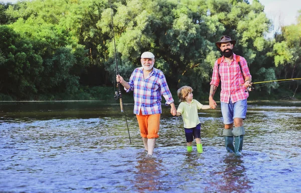 人类家庭钓鱼。父亲、儿子和祖父在一起放松。爷爷和爸爸带着可爱的孩子在钓鱼. — 图库照片