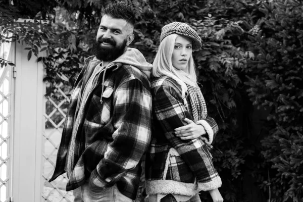 Hipster style. Lumberjack style. Couple wear checkered clothes nature background. Man bearded hipster and girl wear kepi hat. Checkered style. Couple handsome bearded hipster and fashion girl — Stockfoto