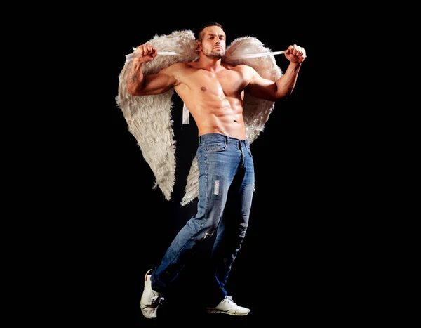 Man with angels wings naked torso. Handsome athletic sexy man in angel costume on black background. Valentines day. — Stockfoto