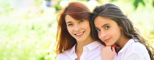 Spring banner with women girlfriends outdoor. Women female beauty. People friendship concept - smiling young women talking outdoor. — Stockfoto