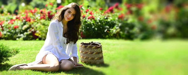 Spring design with beautiful woman for banner or website header, copy space. Spring young woman in summer fields. Happy girl outdoors in field. Woman enjoy outdoor recreation. Natural beauty. Spring — Stock fotografie