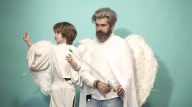 Angels father and son with wings holding bow and arrow. Happy valentines day. Parenting, parent with child boy, childhood.