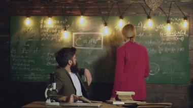 High school student. Teacher and college student in classroom preparing for university exams.