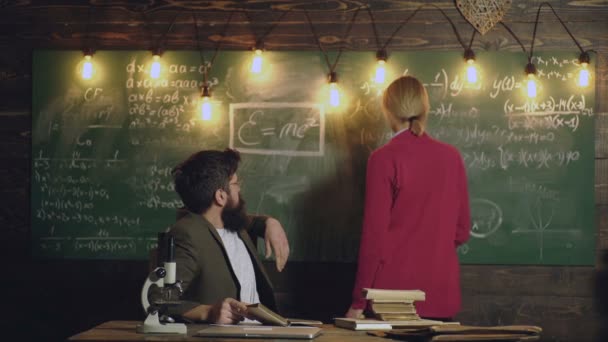 High school student. Teacher and college student in classroom preparing for university exams. — Video