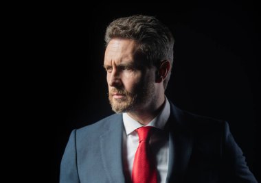 Confident businessman. Middle-age business man in formalwear suit isolated on black. People, business, fashion and clothing concept, closeup of man in suit and necktie.