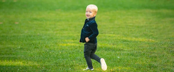 Banner with spring kids portrait. Little kid on spring field. Happy childhood. Child on grass. — 图库照片