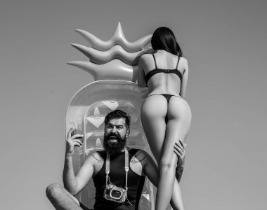 Summer vacation. Sexy woman butt in bikini. Summertime concept. Man in swimsuit. Couple at beach.