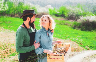Become organic farmer. Worker family agriculture. Gardening in spring - happy couple harvesting and having lots of fun. I love our moments in the countryside.