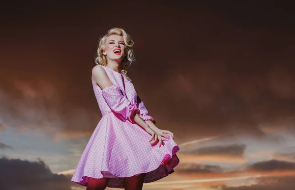 Woman in monroe dress on dramatic sky. Stylish fashion woman posing outdoor. Attractive young woman in sexy dress enjoying summer. — Stockfoto