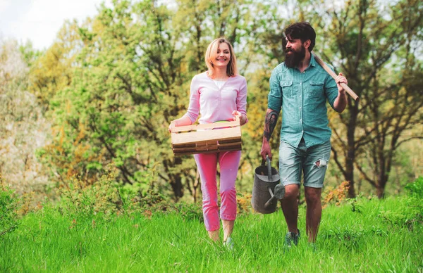 Frau und Mann pflanzen im Gemüsegarten. Ein Bauernpaar sät im Garten Triebe aus. Bauernpaar bei der Feldarbeit. — Stockfoto