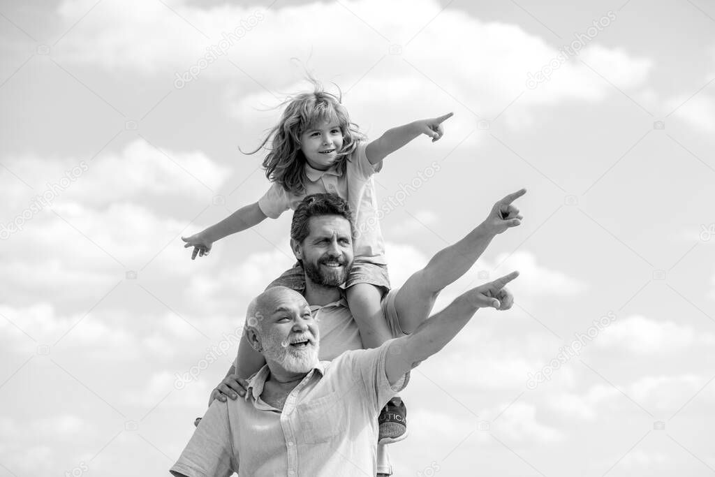 Father and son with grandfather was excited with pointing finger. Hand gestures point. Happy generational muti three generation men family portrait.