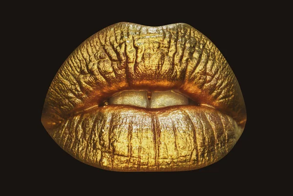 Gold lips, golden gloss lipstick. Luxury gold lips make-up. Golden lips with golden lipstick. Gold paint on lips of sexy girl. Sensual woman mouth, isolated background.
