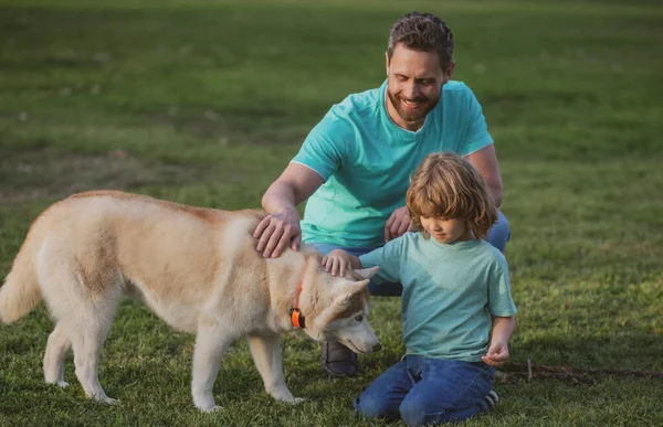 Pai e filho com cão no parque. — Fotografia de Stock