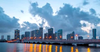 Miami Panorama zaman aşımı. Miami plaj şehrinde gece gökyüzü zamanı. Gökdelen binalarının zaman atlaması. MacArthur şehir merkezinde, Causeway şehrinde..