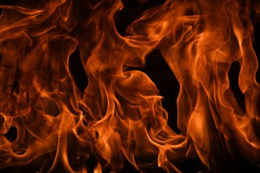 Siyah arka planda ateş dokusu. Soyut yangın arka planı, büyük yanan ateş.