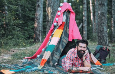 Düz kamp seyahati ile yürüyüş ve açık hava eğlencesi kavramı. Baraka dekore edilmiş parti. Bedava adam için ev yapımı çadır kurma. Yazın mutlu bir adam.