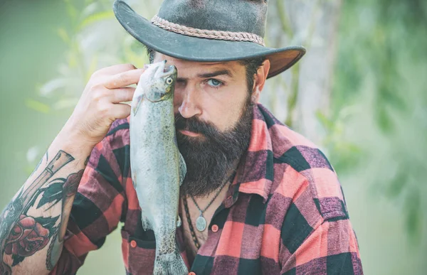 Close up bearded man catching fish. Successful catch. Big game fishing. Weekends made for fishing. Happy fly fishing. Happy fisherman near water. Handsome man relaxing. — Stock Photo, Image