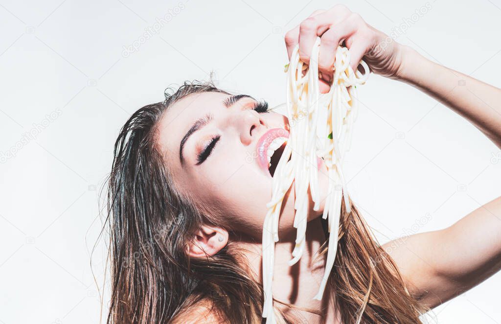 Woman with holds noodles. Long pasta macaroni. Healthy food concept. Diet, healthy organic food. Beautiful girl with spaghetti. Sexy woman eat spaghetti with hands.
