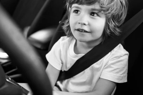 Child driver. Cute child boy while driving car as driver. Baby kid sitting in seat. — Stock Photo, Image