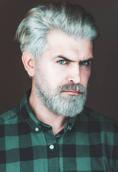 Beautiful guy in shirt looking to the camera isolated over grey background.