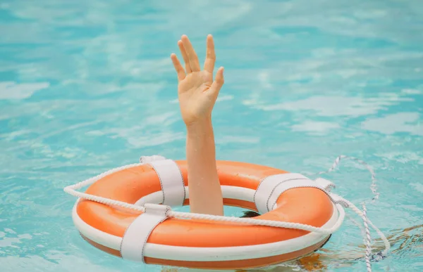 Helping hand. Life problems. Drowning person. Rescue swimming ring in water. Safety water equipment.