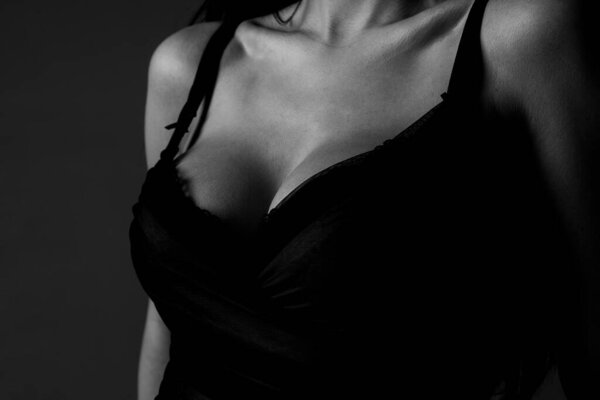 Lingerie bra model. Women breasts. Sexy breas, boobs in bra, sensual tits. Beauty slim female body. Closeup of sexy girl boob in black bra